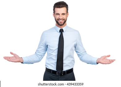 You are always welcome! Confident young handsome man in shirt and tie stretching out hands and smiling while standing against white background  - Shutterstock ID 439433359