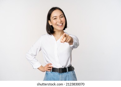 Its you. Beautiful young asian woman, company manager pointing finger at camera and smiling, choosing, inviting people, recruiting, standing over white background - Shutterstock ID 2123830070