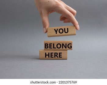 You belong here symbol. Wooden blocks with words You belong here. Beautiful grey background. Businessman hand. Business and You belong here concept. Copy space. - Shutterstock ID 2201375769