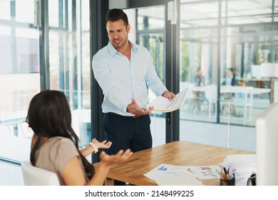 You call this a sales report. Shot of an angry businessman confronting his colleague about paperwork in the office. - Shutterstock ID 2148499225