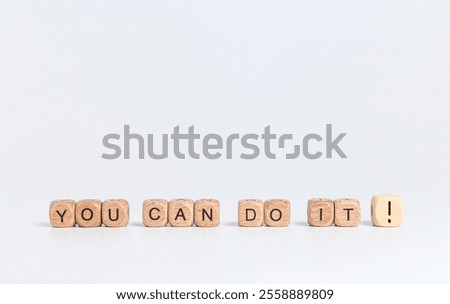 you can do it! phrase on wooden blocks with black letters on white background
