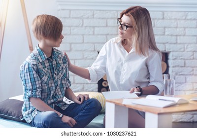 You Can Trust Me. Careful Psychology Professional Putting Her Hand On A Shoulder Of A Young Patient While Talking To Him And Trying To Calm Him Down.