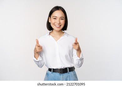 Its you congrats. Smiling attractive asian woman, businesswoman pointing fingers at camera with pleased face, complimenting, inviting you, standing over white background - Shutterstock ID 2122701095