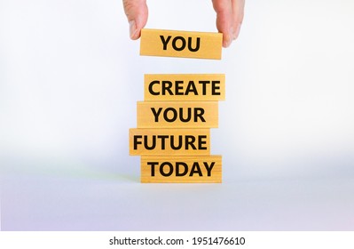 You create your future today symbol. Concept words 'You create your future today' on wooden blocks on a beautiful white background. Businessman hand. Business, motivational and create future concept.