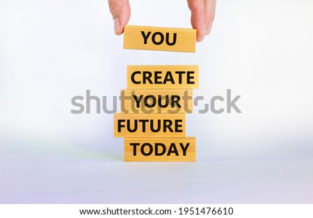 You create your future today symbol. Concept words 'You create your future today' on wooden blocks on a beautiful white background. Businessman hand. Business, motivational and create future concept.