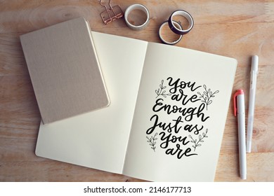 You are enough just as you are. Inspirational motivating quote on notebook with retro filter effect