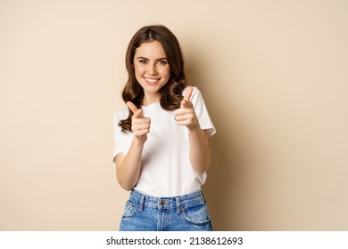 You Got This, Congrats. Smiling Young Woman Pointing Fingers At Camera, Cheering, Complimenting, Standing Over Beige Background