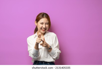 You Got This. Friendly Smiling Woman Congrats, Pointing At Camera And Smiling, Praising Good Jog, Inviting To Event, Standing On Pink Background.