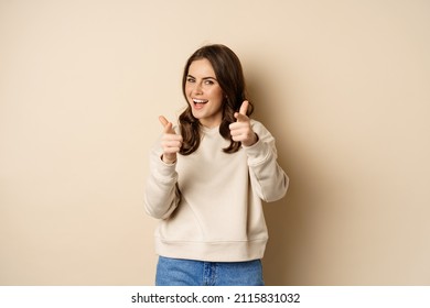 You Got This. Happy Young Woman Pointing Fingers At Camera, Praising, Complimenting, Congrats Gesture, Standing Over Beige Background