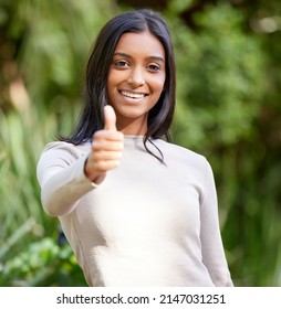 You Got This. Shot Of A Beautiful Young Woman Showing Thumbs Up While Standing Outside.