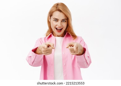 You Got This. Smiling Young Woman Pointing Fingers At Camera, Congratulating, Praising You, Standing Over White Background