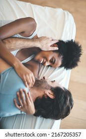 You Have The Most Beautiful Face In The World. High Angle Shot Of An Affectionate Young Couple Smiling At Each Other While Lying On Their Bed At Home.