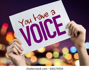 You Have a Voice placard with night lights on background