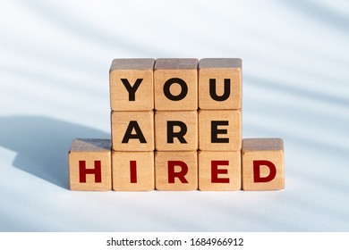 You Are Hired Phrase On Wooden Dices. Employment Or Business Concept