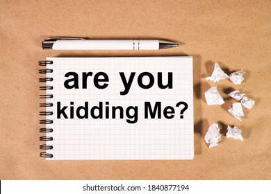 Are You Kidding Me? Text On Notepad On Craft Background Near White Pen And Torn Paper