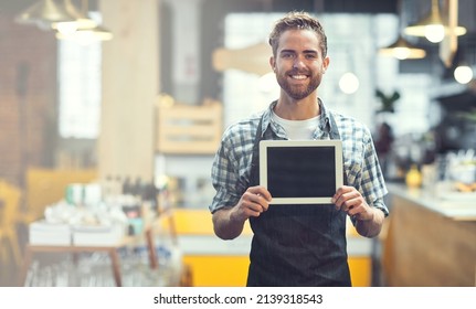 If You Like Our Store, Check Out Our App. Portrait Of A Young Man Showing A Blank Screen On A Digital Tablet In His Store.