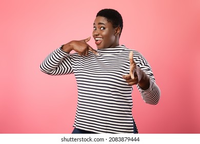 You And Me. Cheerful Black Lady Pointing Finger At Herself And At Camera Smiling To Camera Posing On Pink Studio Background. You'll Choose Me Concept
