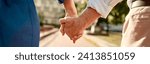 You and me forever. Close-up of elderly couple holding hands while walking together outdoors