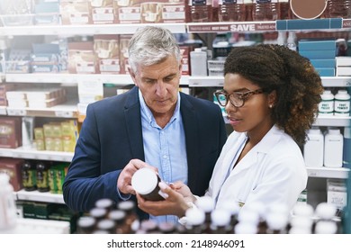 You Might Want To Use This. Shot Of A Helpful Young Female Pharmacist Helping A Customer With Choosing The Right Medication In The Pharmacy.