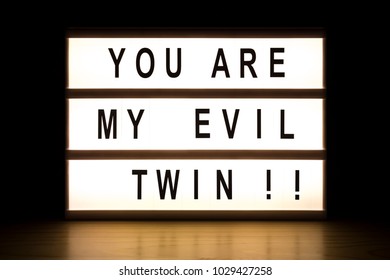 You Are My Evil Twin Light Box Sign Board On Wooden Table. 