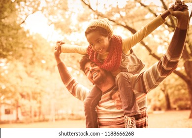 You Are My Little Hero. African American Father With Daughter. Little Girl Sitting On Father Shoulders.