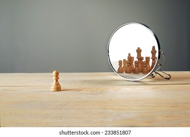 You are not alone. Chessmen in front of the mirror