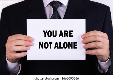 You Are Not Alone placard with bokeh background