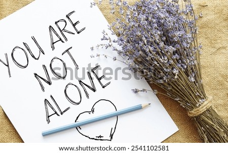 You are not alone is shown using a text
