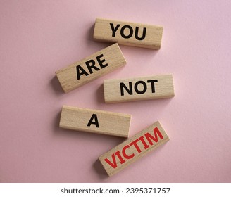 You are not your a victim. Wooden blocks with words You are not a victim. Beautiful pink background. Business and You are not a victim. Copy space. - Shutterstock ID 2395371757