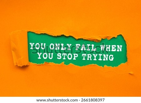 You Only Fail When You Stop Trying message written on ripped torn orange paper on green background. Conceptual You Only Fail When You Stop Trying symbol. Copy space.
