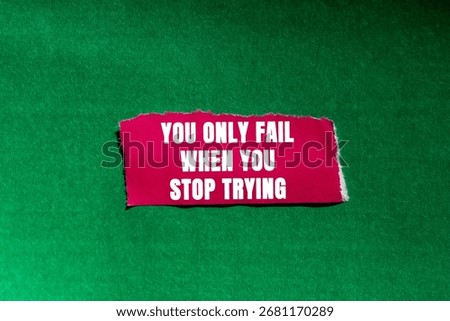 You Only Fail When You Stop Trying message written on ripped torn pink paper piece on green background. Conceptual You Only Fail When You Stop Trying symbol. Copy space.