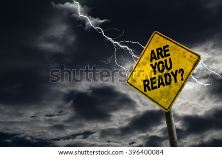 Are You Ready sign against a stormy background with lightning and copy space. Dirty and angled sign adds to the drama.