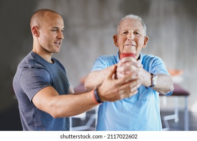 You say senior, I say strong. Shot of a senior man working out with the help of a trainer. - Powered by Shutterstock