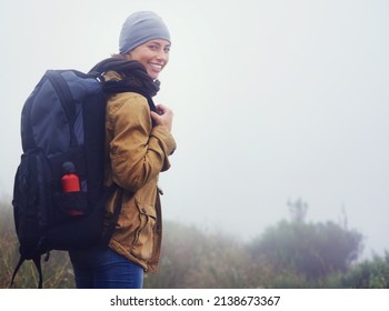 You Should Join Me.... Portrait Of A Young Woman Hiking Along A Trail On An Overcast Day.