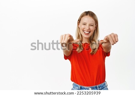 Its you. Smiling blond girl pointing fingers at camera, its you, congrats gesture, congratulating, standing over white background