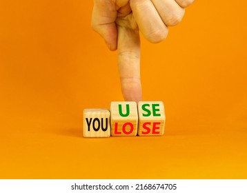You use or lose it symbol. Concept words You use and You lose on wooden cubes. Businessman hand. Beautiful orange table orange background. Business and you use or lose it concept. Copy space. - Shutterstock ID 2168674705