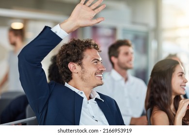 If You Want To Know Something, Ask. Cropped Shot Of A Handsome Young Businessman Raising His Hand During A Seminar.