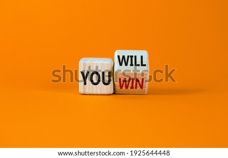 You will win symbol. Turned a wooden cube and changed words you will to you win. Beautiful orange background, copy space. Business, motivational and you will win concept.