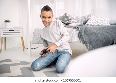 You Win. Energetic Afro American Boy Showing Tongue While Passing Video Game Level