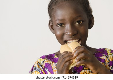 Youg African Girl Eating Some Bread - Isolated On White