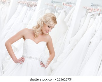 Youg Girl Is Trying On An Amasing Wedding Gown, White Background