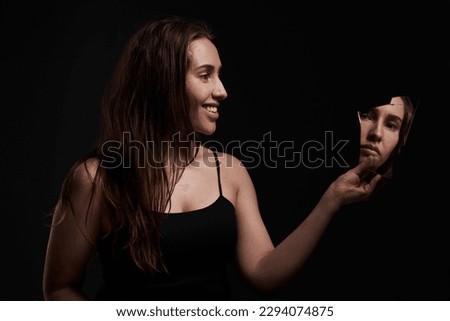 Youll never be in control. Shot of a creepy woman grinning at her reflection in a broken mirror.