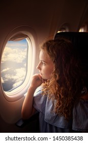 Youn Girl Looks Outside The Window In Plane