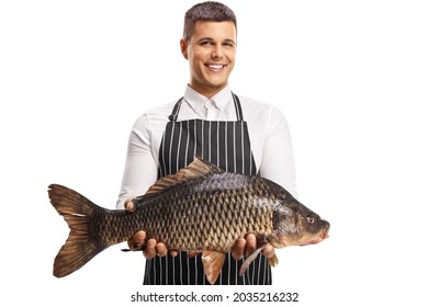 Youn Man Wearing Apron And Holding A Big Carp Fish Isolated On White Background