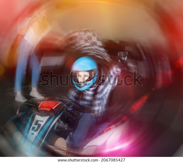 Youn sportive woman driving\
sport car for karting in sport club, woman with race flag on\
background