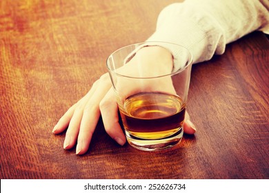Yound beautiful woman in depression, drinking alcohol