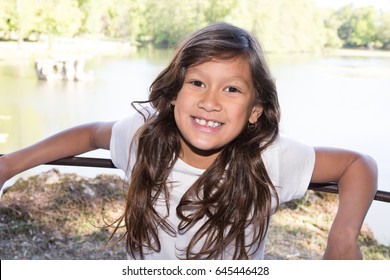 Young 10 Year Old Girl Near Lake Park