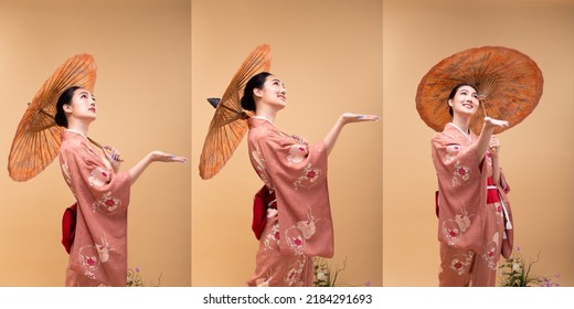 Young 20s Asian Japanese woman wear traditional Kimono, hold painting umbrella and hand for rain. Japan Kimono female express felling happy smile over pastel yellow background isolated copy space