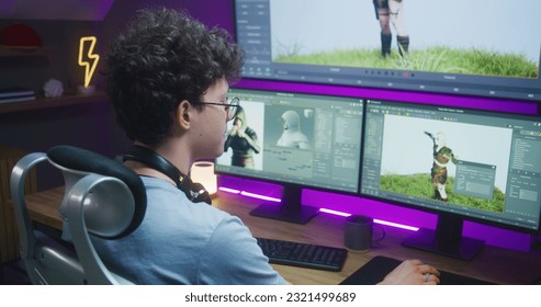 Young 3D designer draws video game character, creates animation. Teenager works remotely at home on computer and big digital screen with professional software interface for 3D modeling and design. - Shutterstock ID 2321499689