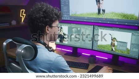Young 3D designer draws video game character, creates animation. Teenager works remotely at home on computer and big digital screen with professional software interface for 3D modeling and design. Foto stock © 